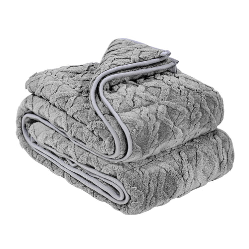 Grey sherpa fleece weighted blanket folded on a bed