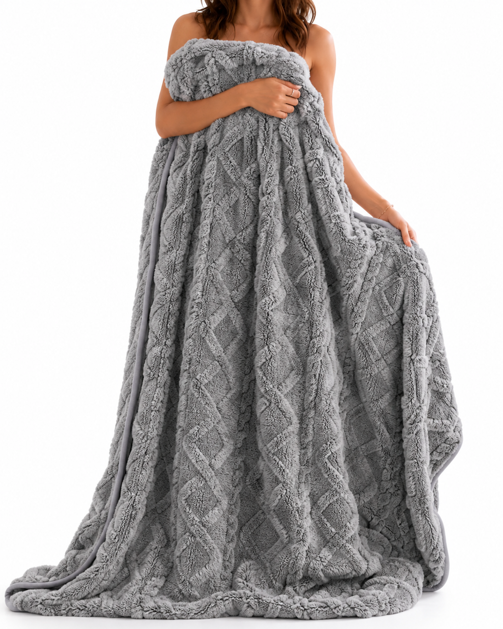Grey cable-knit textured blanket held by a standing model